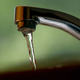 Tap water flows from a faucet.